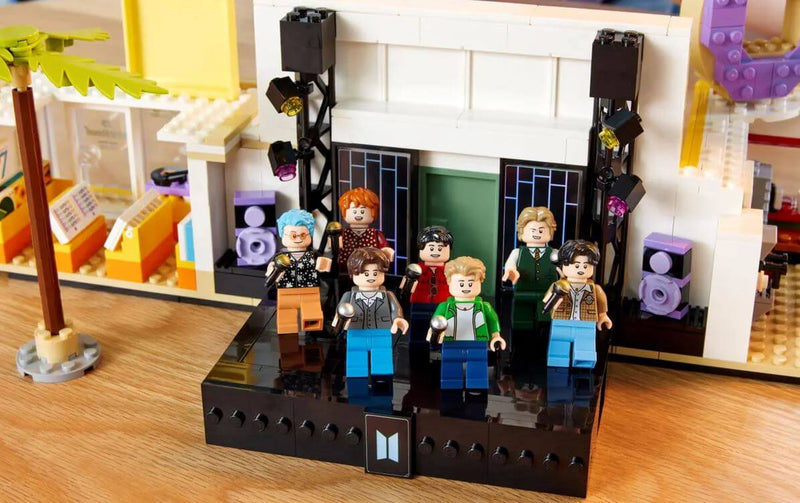 LEGO Ideas BTS Dynamite set featuring minifigures RM, Jin, SUGA, j-hope, Jimin, V, and Jung Kook on stage.