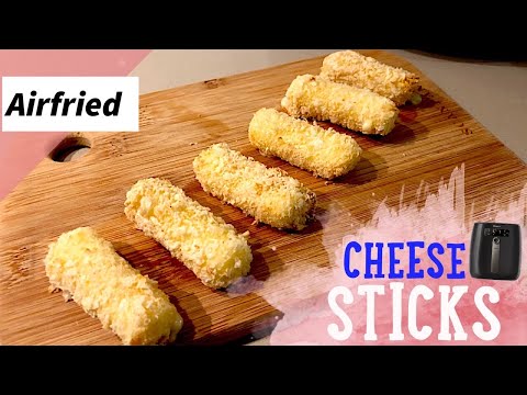 Airfried cheese sticks arranged on a wooden board, showcasing a crispy golden coating, ideal for healthy snacking.